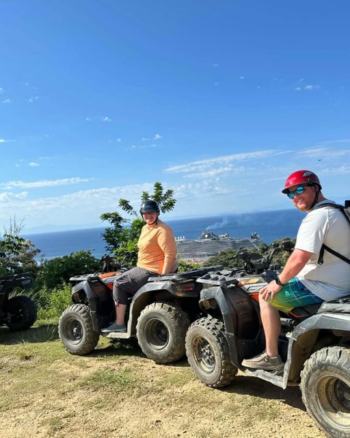 ATV riders at a hilltop lookout over the coast
