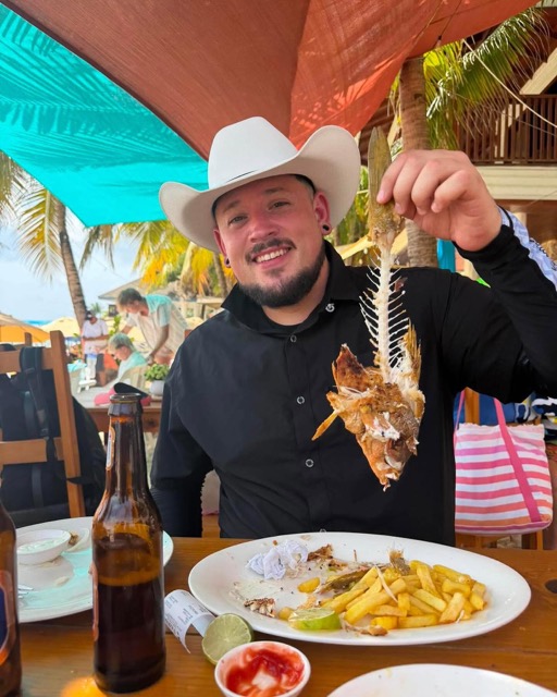 Guest showing a starfish at a beachside lunch stop