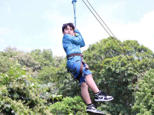 Guest ziplining over the jungle canopy