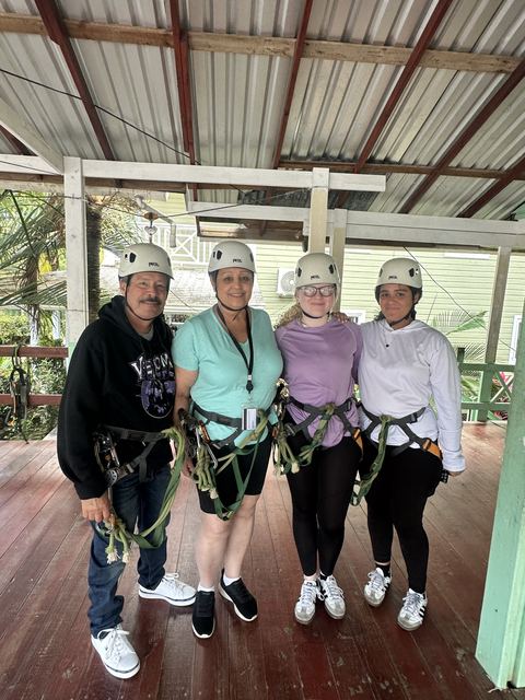 Four guests in helmets and harnesses ready to ride at the platform